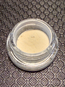 A glass jar with THCA powder
