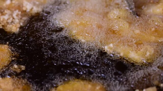 Golden Banana Slices Sizzling in Hot Oil with Crispy Sweet Treat,Banana fritter,The banana and pineapple  fritters are frying in a hot pan