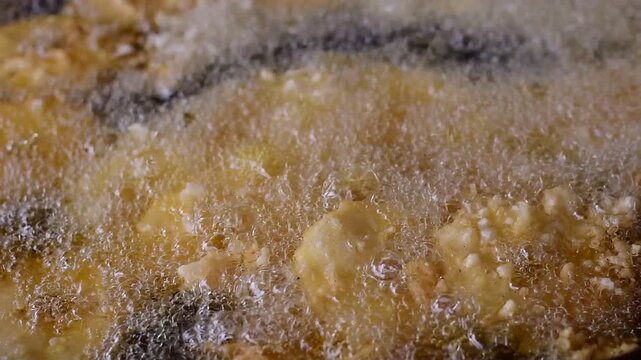 Golden Banana Slices Sizzling in Hot Oil with Crispy Sweet Treat,Banana fritter,The banana and pineapple  fritters are frying in a hot pan