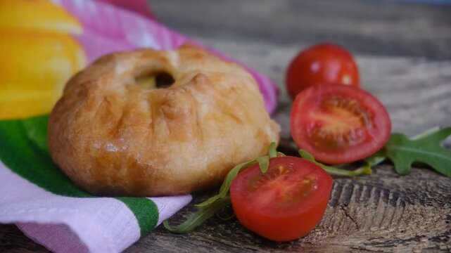 Mongolian buuz, dumplings with meat, savory fried dumplings filled with juicy meat, served on a plate with herb, arugula, tomatoes. Artisanal food	