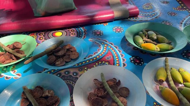 Fresh and Dried Areca Nuts Displayed on Colorful Traditional Table