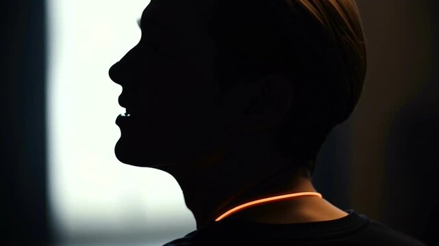 Silhouette of a man in contemplation indoors.