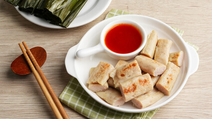 Otak-otak Tengiri, made from fish and flour covered with banana leaf. Served with chilli sauce. Indonesian food