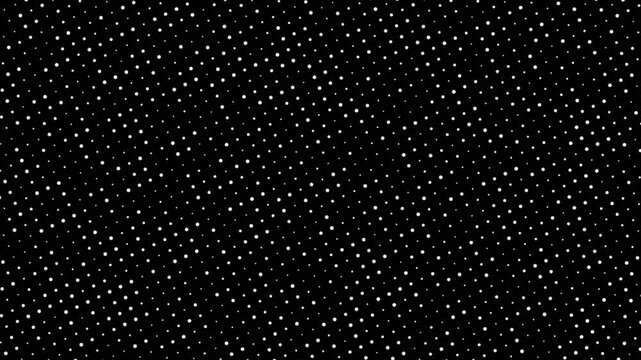 A close-up view of a dark surface covered with numerous small, uniformly distributed light-colored dots, creating a textured pattern.