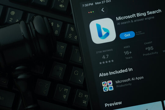 Dhaka, Bangladesh- 28 Oct 2025: An iPad displaying the Microsoft Bing app against a judge's gavel and dark keyboard background.