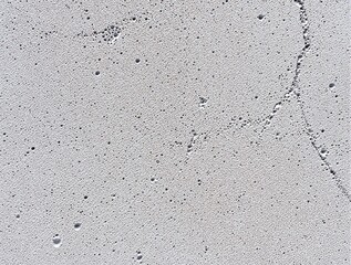 Fototapeta premium Abstract Grey Porous AAC Brick Surface Texture. High-detail top-view of a grey textured surface with tiny holes and pores, resembling concrete, stone, or solidified foam.