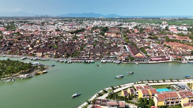 Hoi An (Hoian), Da Nang City (Quang Nam), Vietnam: 4K aerial drone footage of ancient town, UNESCO heritage, Hoai river, boats, lantern streets and historic waterfront