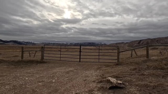 Looking west on a very windy afternoon, this time-lapse video shows clouds moving under the sun. Red gate is the entrance to this ranchers pasture near Casper Mountain, in Casper Wyoming.