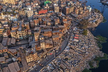 Obraz premium An Aerial view shows an informal plastic waste recycling zone lining the banks of the Buriganga River in the Sadarghat area of Dhaka, Bangladesh.
