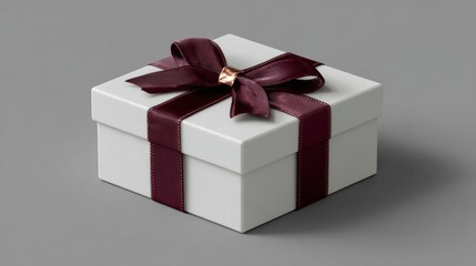 Obraz premium An Elegant Gift: A meticulously produced, pure white parcel, adorned with a regal, crimson satin band, conjures a sense of eagerness and genuine donation