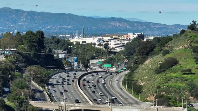 Telephoto drone shot of traffic on Freeway 101 at Cahuenga Pass in Los Angeles
