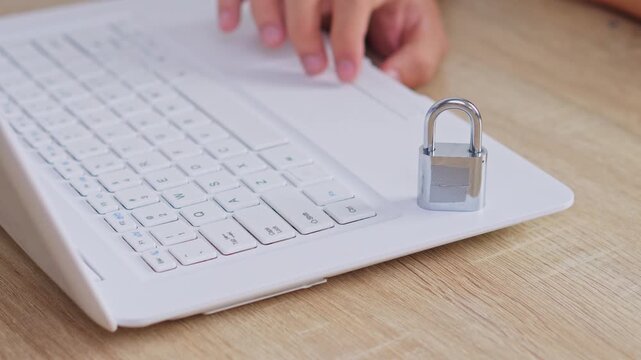 Cyber security concept silver padlock locking white computer keyboard