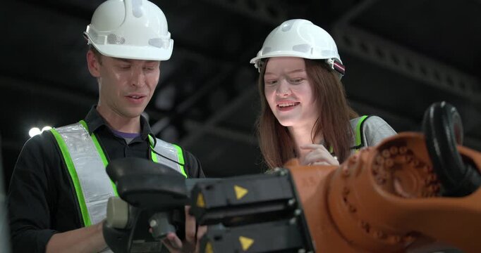 Engineering supervisor mentors trainee in robotics environment, emphasizing the importance of leadership, communication, and continuous education in managing complex machinery and technical processes
