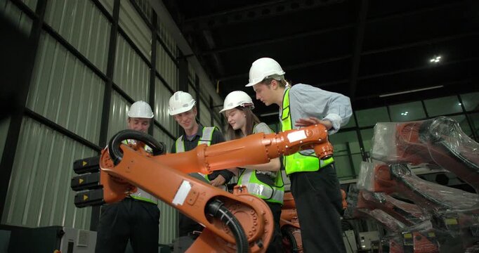 Engineering supervisor mentors trainee in robotics environment, emphasizing the importance of leadership, communication, and continuous education in managing complex machinery and technical processes
