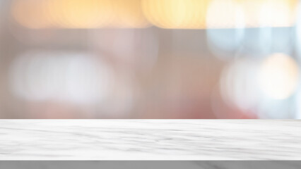 White marble table top with blurred cafe restaurant interior background for product display
