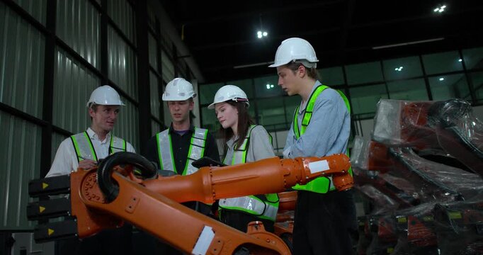 Engineering supervisor mentors trainee in robotics environment, emphasizing the importance of leadership, communication, and continuous education in managing complex machinery and technical processes
