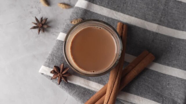 Indian chai served in glass cups, brewed in a metal kettle with aromatic masalas.