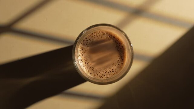 Indian chai served in glass cups, brewed in a metal kettle with aromatic masalas.