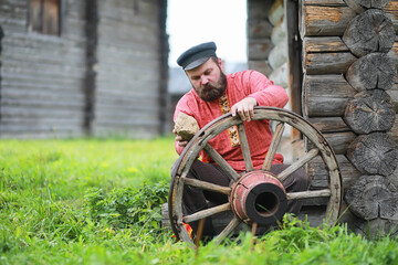 Traditional Slavic rituals in the rustic style. Outdoor in summer. Slavic village farm. Peasants in elegant robes.
