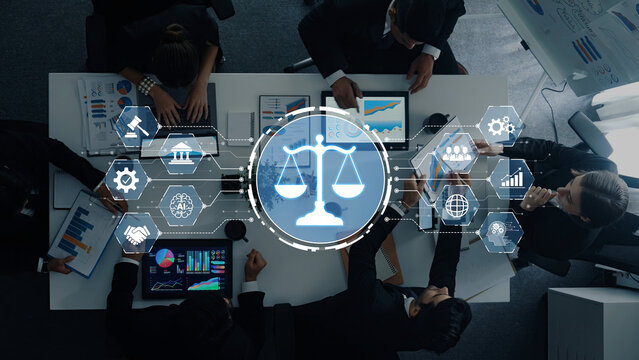A diverse team engages in a business meeting, analyzing charts and data while a digital scale symbolizing law integrates with modern technology and collaboration. Trope