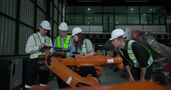 Engineering supervisor mentors trainee in robotics environment, emphasizing the importance of leadership, communication, and continuous education in managing complex machinery and technical processes
