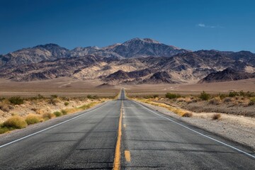 Endless Road to Mountain Majesty Death Valley National Park California Desert Landscape Long Straight Highway Through Arid Terrain Majestic Mountain Vista in Desert Environment
