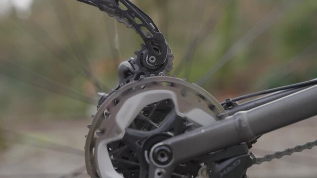 Close up of bike chainring and derailleur moving during road cycling