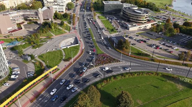 Drone pulls back and rises over heavy rush hour traffic in Vilnius