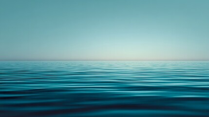 Obraz premium Vast expanse of tranquil blue ocean under a clear sky.