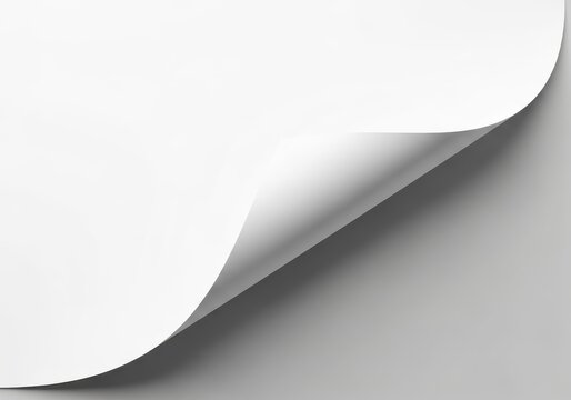 Blank white paper sheet displays a corner turned over showing shadow and background surface