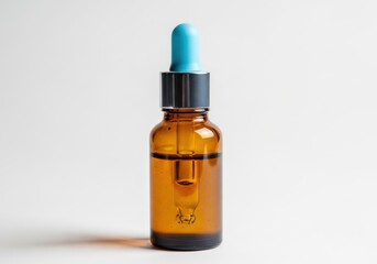 Fototapeta premium Amber glass dropper bottle with blue bulb stands against a light background