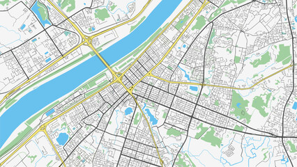 Obraz premium Detailed top down view of a city street map showing roads buildings parks and a large blue river for navigation and urban planning applications.