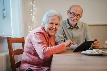 Fotobehang Onderzeeër Senior coule working with tablet, making reservation or shopping online.  © Halfpoint