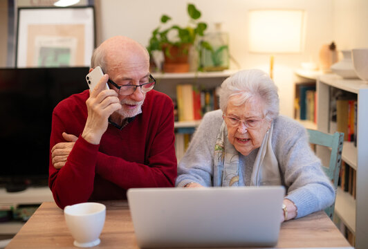 Old people having problem with laptop, calling for help.