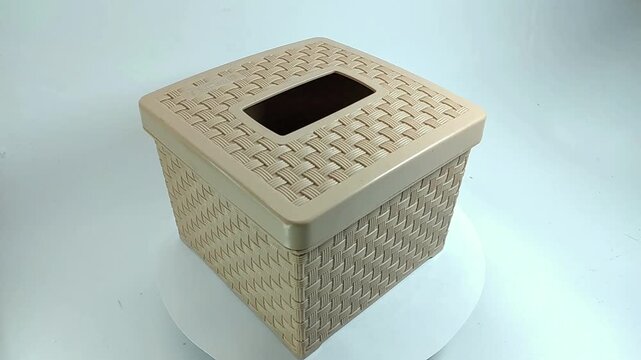 Square tissue box with woven texture rotating isolated