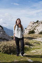 Naklejka premium Young woman enjoying hiking on mountain trail