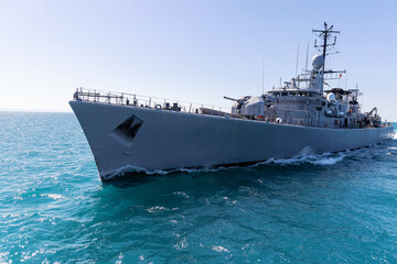 Obraz premium Warship during mission on sea. military frigate sail on black sea.
