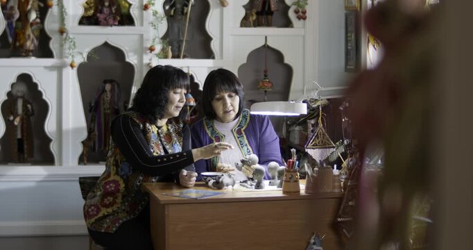 Women Crafting Traditional Folk Dolls in Artisan Workshop