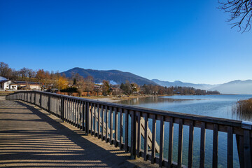 Naklejka premium The Mangfallsteg, a striking wooden bridge in Gmund am Tegernsee in Bavaria. The footbridge is a popular spot for hikes and bike rides and offers a picturesque view of the surrounding countryside