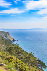 Fototapeta premium Rocky coastline by the sea a sunny summer day