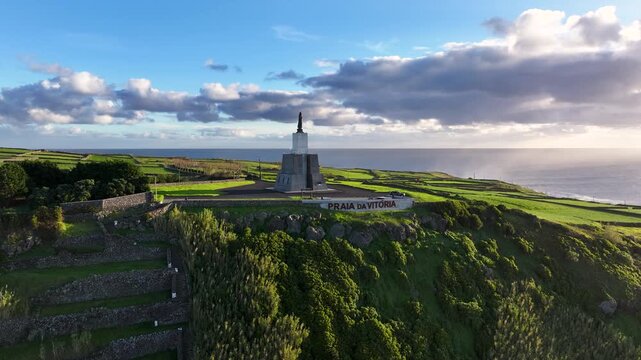 Sunrise aerial toward Serra do Facho viewpoint with statue in Praia da Vit&oacute;ria