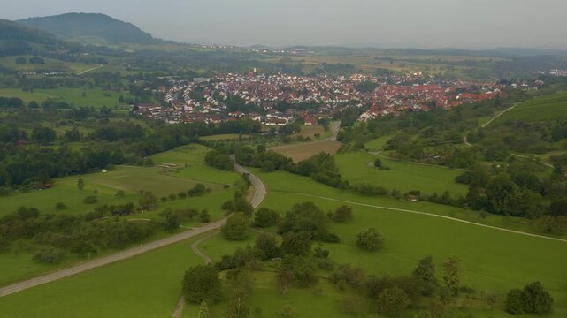 An panoramic aerial View beside the village Neuffen and castle Burg Hohenneuffen in Germany  on an early morning with clouds in spring.