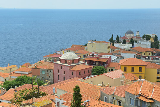 Kavala old town buildings overlooking the Aegean Sea. Kavala old town houses with red roofs and historical buildings overlooking the blue sea.