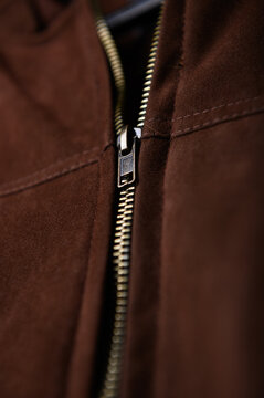 close up of zipper jacket. brown jacket. close up of fabric. garment textile.