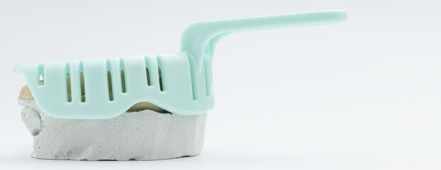 Dental impression tray on plaster tooth model © Maximusdn