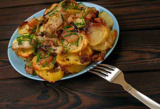 fresh natural fried potatoes with lard and green onions
