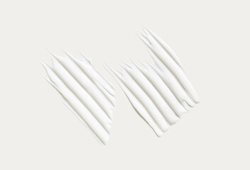 cosmetic smear of creamy texture on gray background