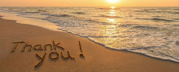 Thank You Message Written in Beach Sand at Sunset  
