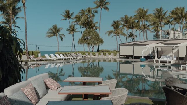 Dining tables next to the hotel swimming pool. Mokapu Beach Park. Wailea Beach Paths, South Maui, Hawaii. Andaz Maui at Wailea Resort. The coconut (Cocos nucifera) is a member of the palm family 