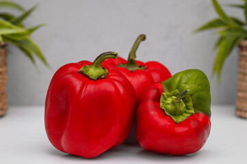 Organic sweet red peppers, whole, picked from my own garden, on the table